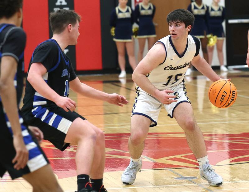Marquette's Alec Novotney brings the ball up against Hinckley-Big Rock's Austin Roop Tuesday, March 3, 2026, during their sectional semifinal matchup at Amboy High School.