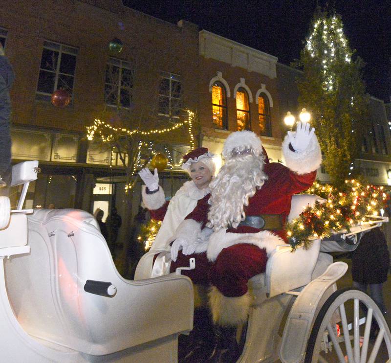 Santa and Mrs Clause wave to the crowd gathered along La Salle St in Ottawa Friday during the Festival of Lights Parade.