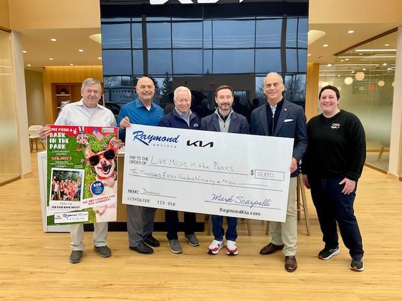 Lake Villa Township Supervisor Dan Venturi (from left), Village of Lindenhurst Mayor Dominic Marturano, Village of Lake Villa Mayor James McDonald, Lindenhurst Park District Executive Director Dave Mohr, Owner of Raymond Chevrolet Kia in Antioch Mark Scarpelli, Lake Villa District Library Adult Services Outreach Librarian Meg Schmaus. Mark Scarpelli and team invited the Community Partners to a doughnut/coffee breakfast and tour of their brand-new dealership on March 7.  He also presented a sponsorship check for $10,890.
