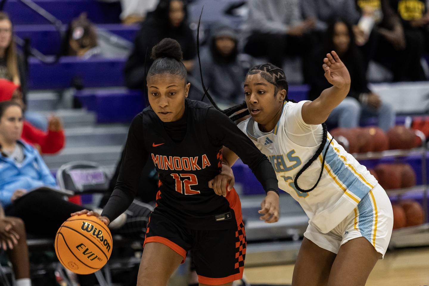 Minooka's Naya Carter goes head to head with Joliet Catholic's Gabrielle Gavin during a WJOL Girls Basketball Tournament game at Joliet Junior College on Nov. 17, 2025.