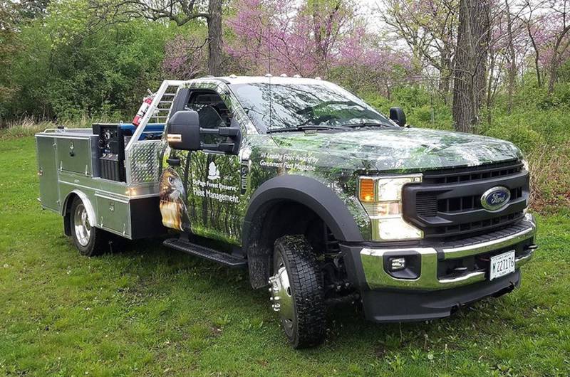 A pickup truck from the DuPage Forest Preserve District's green fleet.