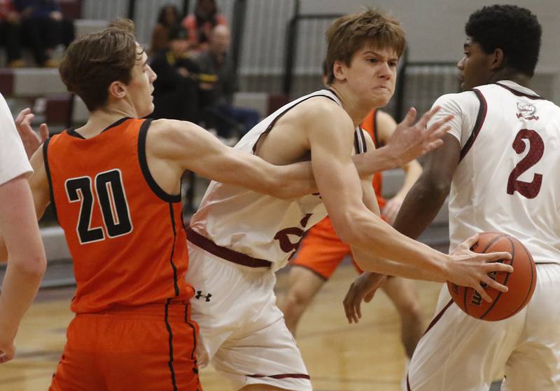 Antioch’s Joel Bulka tries to protect the ball from McHenry's Marcus Honea during a nonconference basketball game Thursday, Jan. 4. 2024, at Antioch High School.