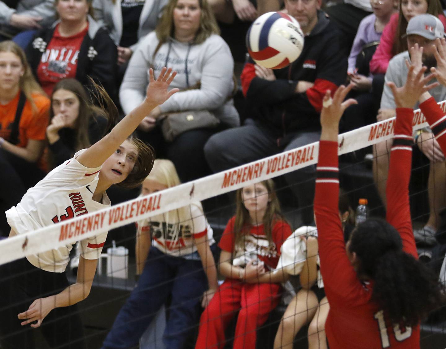 Huntley's Izzy Whitehouse spikes the ball over Mundelein's Sophia Mitry during an IHSA Class 4A McHenry Sectional volleyball match on Tuesday, Nov. 5, 2024, at McHenry High School Freshman Campus.