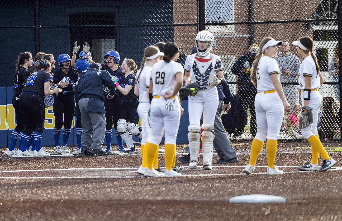 Newman celebrates teammate Brenleigh Cook's homer against Sterling last season.