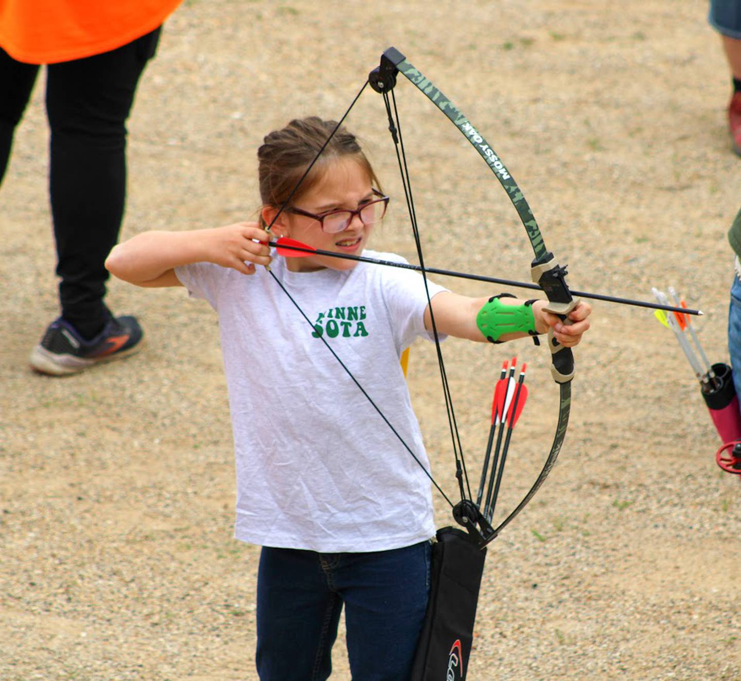 A 4-H member prepares to aim in archery.