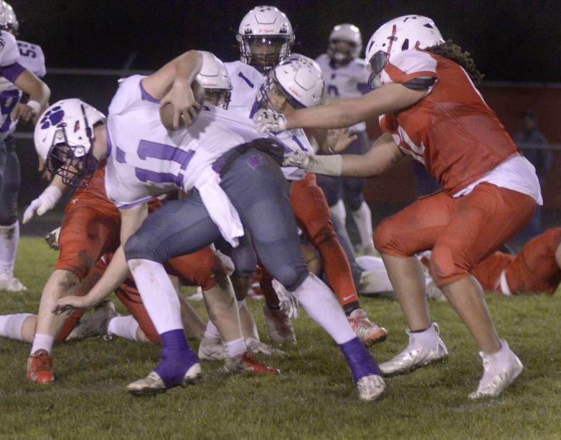 Str Wilmington 5  Streator’s Eric Moton works to pull down Wilmington Quarterback Cade McCubbin on a keeper during 1st quarter Friday at Streator.