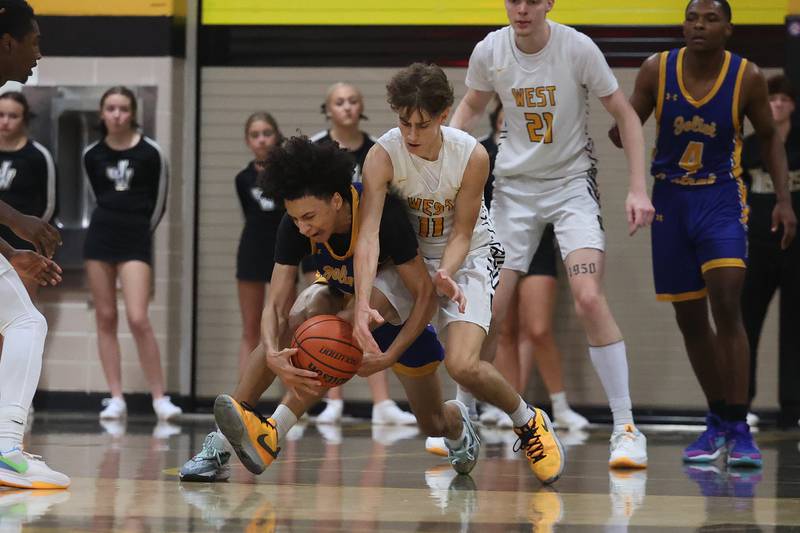 Joliet Central’s Zion Kostra wins the battle for the ball against Joliet West’s Luke Grevengoed on Tuesday, Nov. 28, 2023 in Joliet.