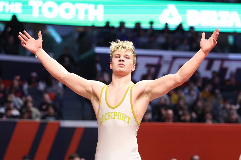 Lockport’s Brayden Thompson raises his arms after a win against Marmion’s Tyler Perry in the Class 3A 170lb. championship match at State Farm Center in Champaign. Saturday, Feb. 19, 2022, in Champaign.