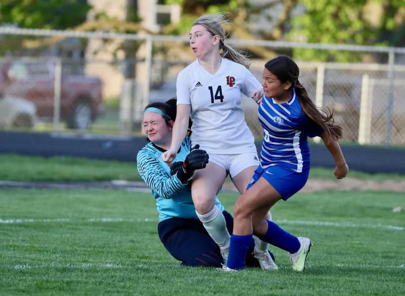 L-P's Nica Hein gets a shot on goal as Princeton keeper Maddie Oertel braces for impact with help from Yocelynn Robledo Tuesday night at Bryant Field. The Cavs won 6-1.