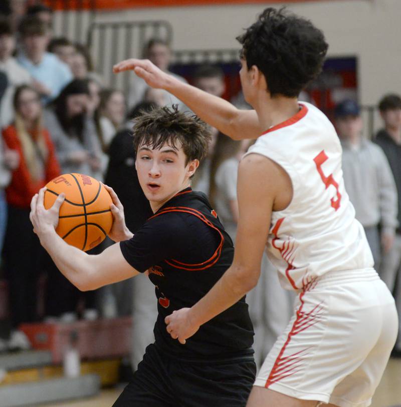 Erie-Prophetstown's Max Milem (left) protects the ball from Oregon's Benito Olade during 2A regional action on Monday, Feb. 24, 2025 at the Blackhawk Center in Oregon.