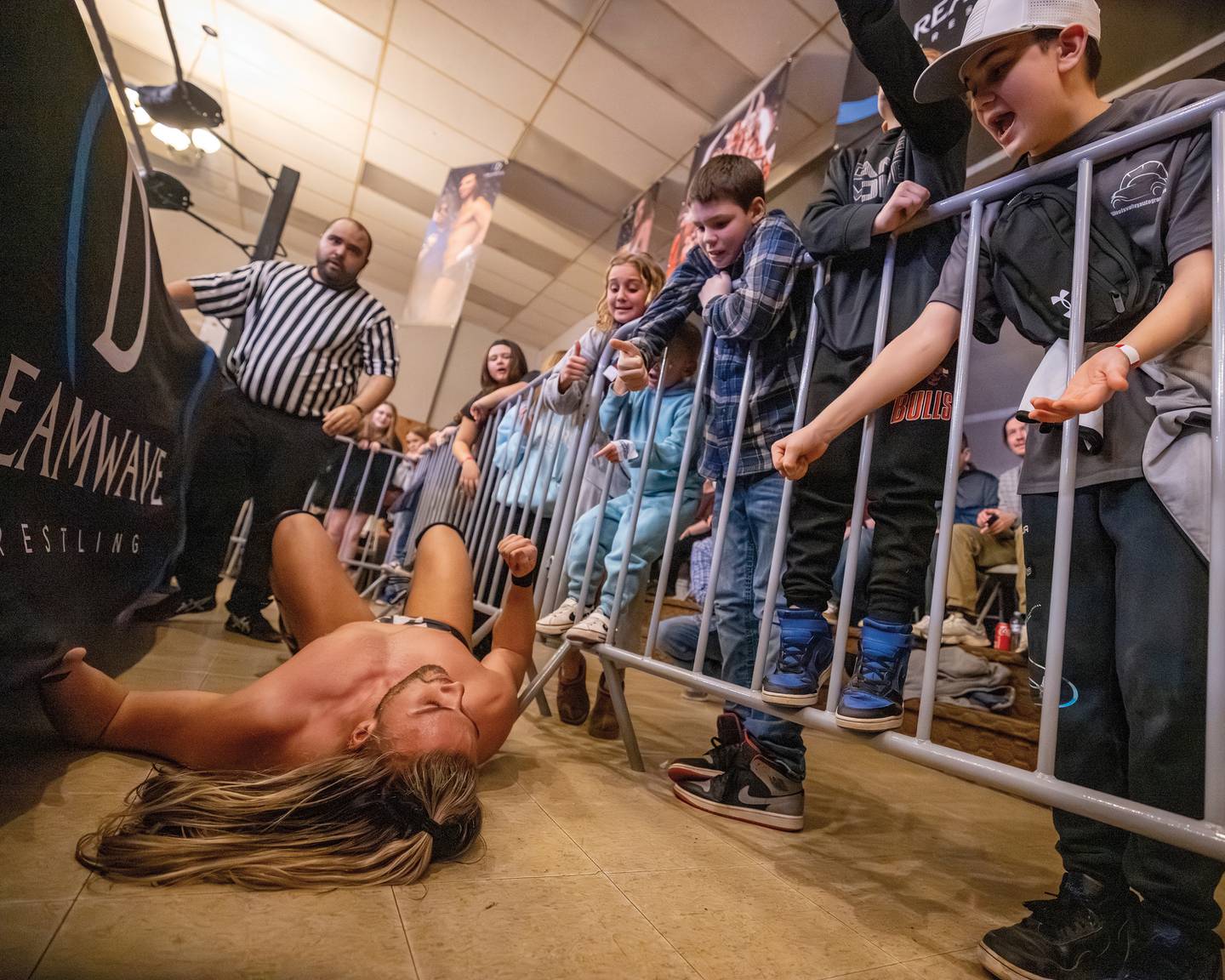 Young fans interact with Sean Logan during his match against Channing Thomas at Dreamwave Wrestling's "Famous Last Words" event Feb. 8, 2025, in La Salle.