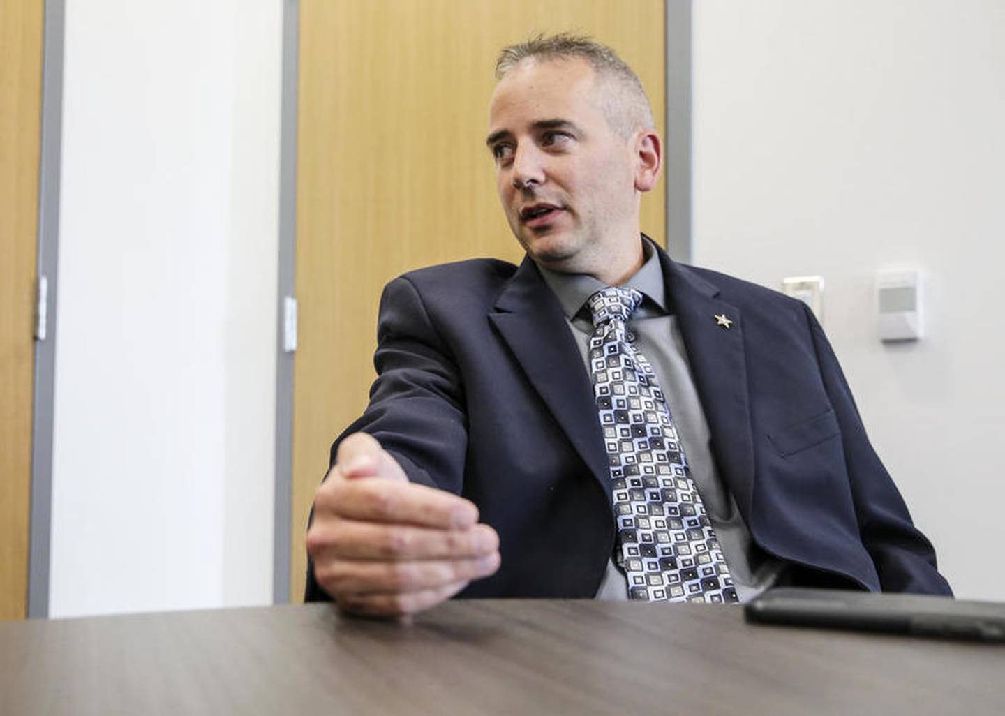 Will County Deputy Chief Dan Jungles explains the benefit of meeting at the Sheriff's Office to exchange money for goods bought online Thursday, July 19, 2018, in Joliet, Ill.