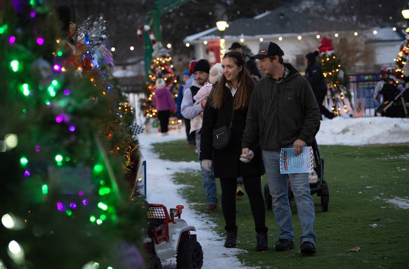 Katelyn Teste and Tony Germain, of Bourbonnais, look at the lighted Christmas trees at the Manteno Christmas celebration on Saturday, December 6, 2025.