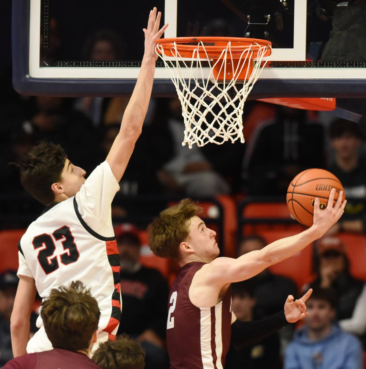 Joe Lewnard/jlewnard@dailyherald.com
Moline's Brock Harding, right, goes for a reverse layup against Benet Academy's Niko Abusara during the Class 4A boys basketball state championship at State Farm Center in Champaign Saturday.