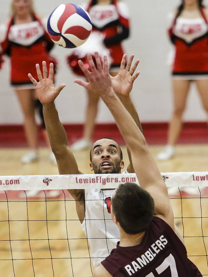 Lewis University's Geoff Powell goes up to block a hit by Loyola's Thomas Zaluski during a match against at Lewis University on Wednesday.