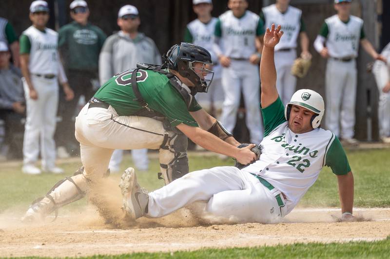 (22) Alan Spencer of St. Bede slides into home plate whilst (30) Z. Schwanke of Midland tags him out on Saturday, May 24, 2025 at Stark County High School in Toulon.