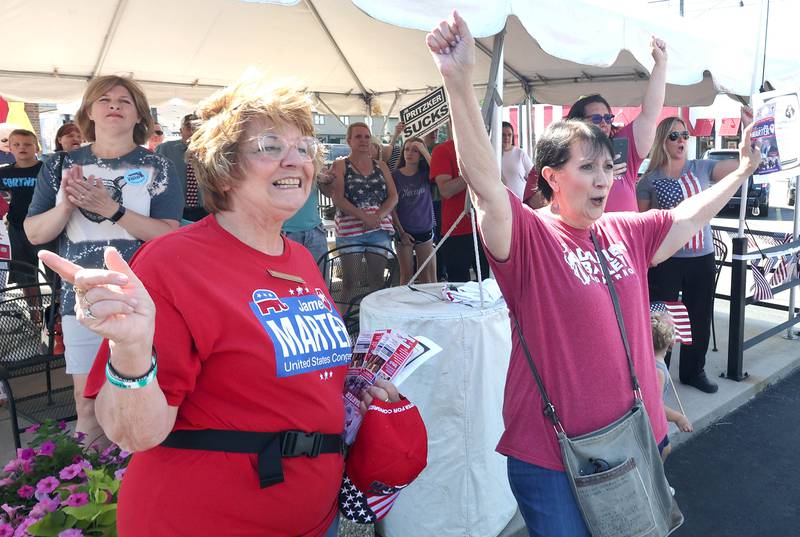 Supporters cheer as the bus carrying Darren Bailey, a Republican candidate for Illinois governor, pulls into Tom and Jerry's in Sycamore Friday, June 17, 2022, for a stop on his campaign bus tour.