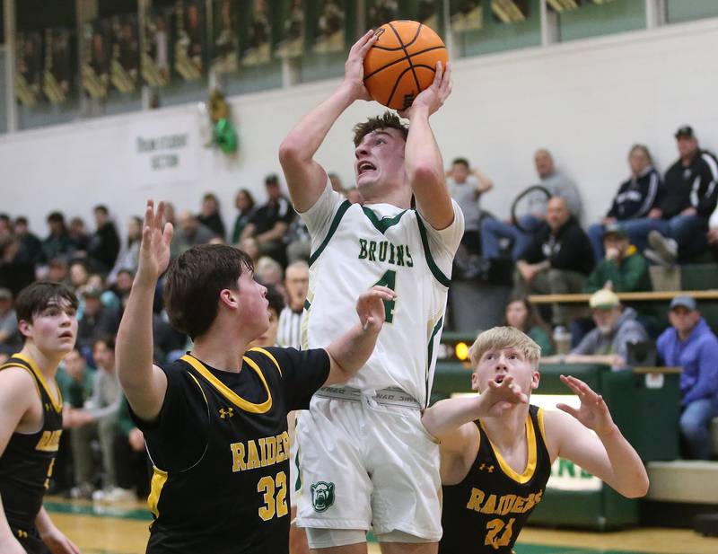 St. Bede's Gino Ferrari eyes the hoop as Ashton-Franklin Center defenders Nolan Rueff and Kyle Goldman swarm the lane during the Class 1A Regional quarterfinal game on Monday, Feb. 24, 2025 at St. Bede Academy.