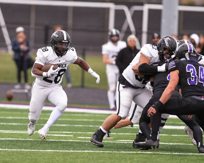 Fenwick's Jalen Morgan, right,  runs the ball and gains some yards before being brought down by Downers Grove North defenders during the second week of the class 7A game on Saturday Nov. 9, 2024, held at Downers Grove North High School.