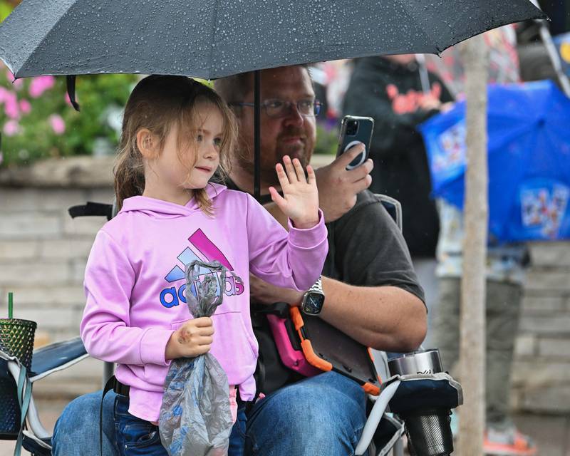 Kinsley Schaffer (5) with her father Brandon Schaffer seen watching the Crystal Lake Central H.S. 100 year homecoming day parade in downtown Crystal Lake on Saturday, Sep. 16, 2023 in Crystal Lake. The parade began at the high school and made its way through downtown Crystal Lake.