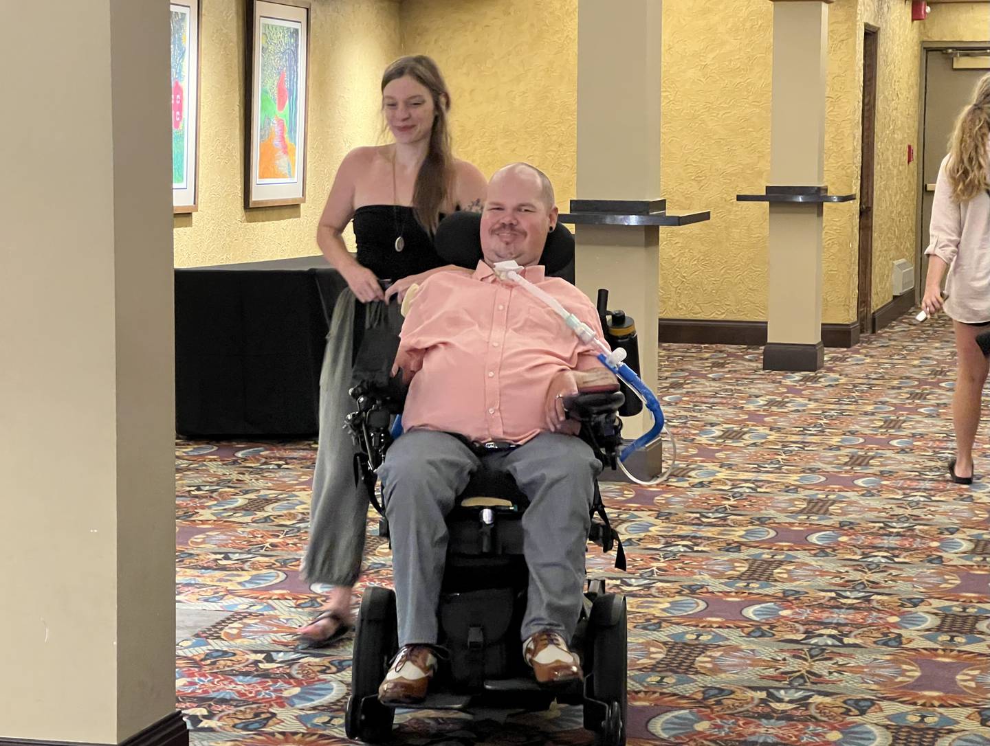 J.J. Wet, helped by his personal assistant Gabby Cigletcki, moves through the lobby of the Egyptian Theatre on July 23, 2023.