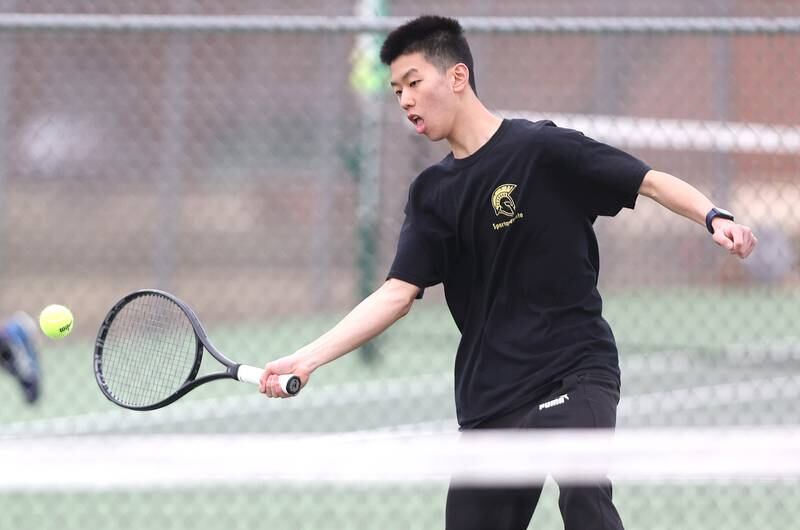 Sycamore’s number one singles player Steven Chen hits a forehand during his match against Dixon Thursday, March 30, 2023, at Sycamore High School. This is the inaugural season for the Sycamore boys tennis team.