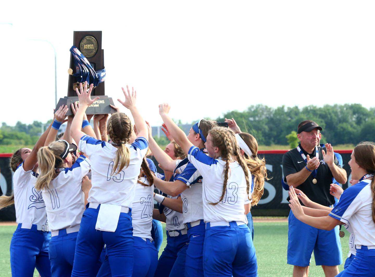 Members of the St. Charles softball team hoist the Class 4A trophy after defeating Chicago Marist 3-2 on Saturday, June 11, 2022 at the Louisville Slugger Complex in Peoria.
