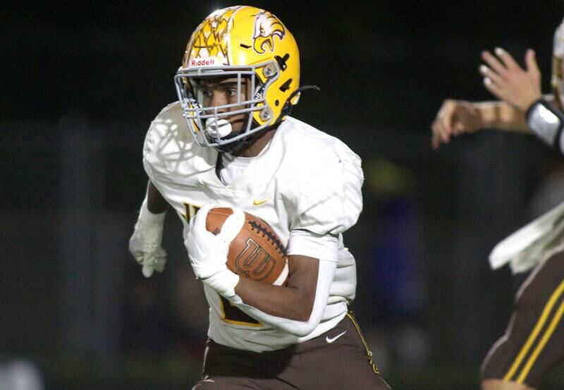 Jacobs’ Mike Cannady runs the ball in varsity football on Friday, Sept. 20, 2024, at Al Bohrer Field on the campus of Cary-Grove High School in Cary.