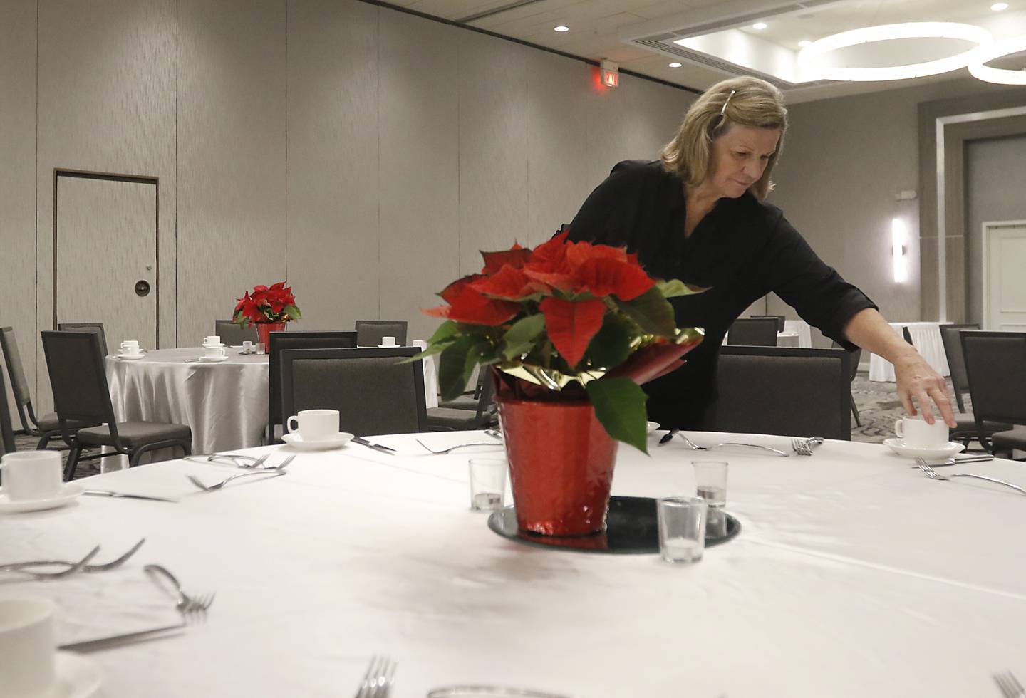 Mary Giersch sets up at the ballroom Friday, Dec. 16, 2022, at the Holiday Inn, 800 S. Route 31 in Crystal Lake, for a Christmas party at the hotel. In-person holiday parties have returned this year after several years of the COVID-19 pandemic curtailing parties.