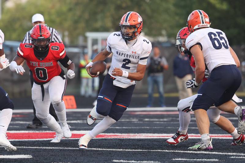 Naperville North quarterback Jacob Bell scrambles out of the pocket against Bolingbrook on Friday, Sept. 8, 2023 in Bolingbrook.