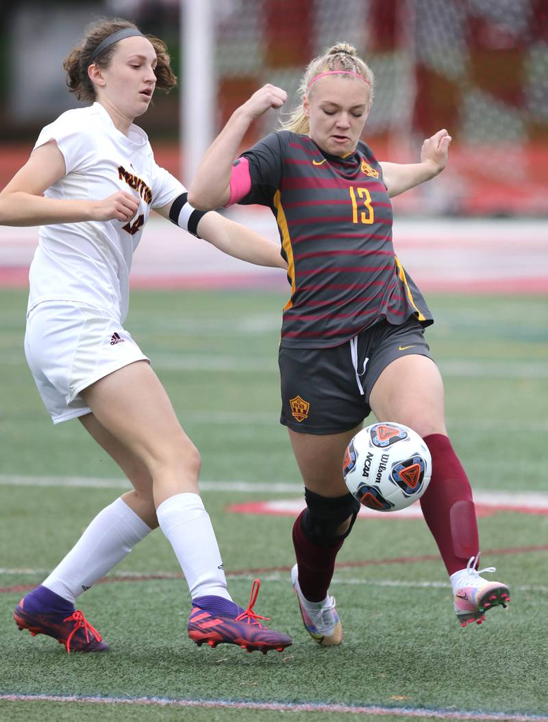 Richmond-Burton's Jordan Otto kicks the ball away from Montini's Sawyer White Friday, May 27, 2022, during their IHSA Class 1A state semifinal game at North Central College in Naperville.