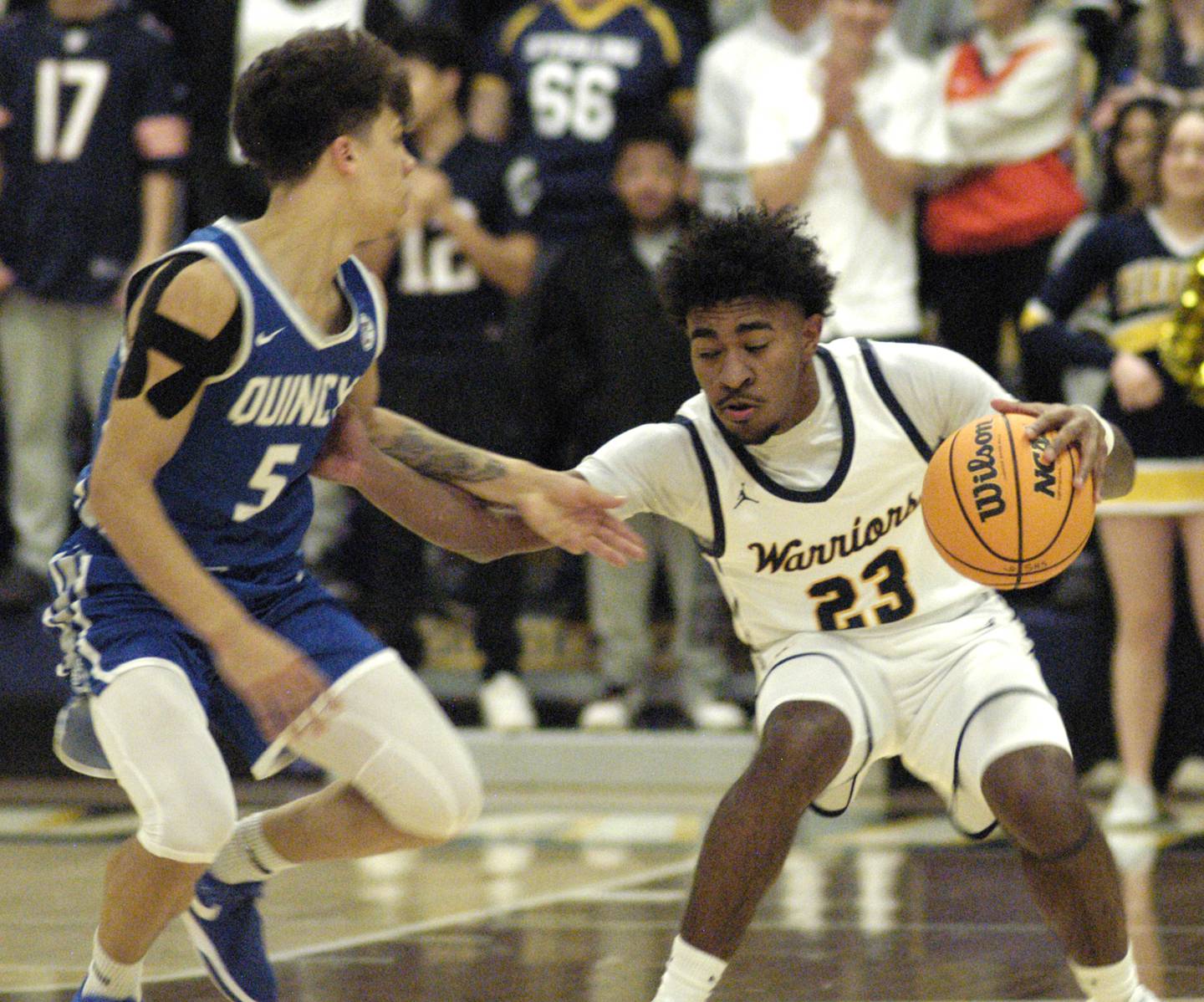 Sterling's Kaedon Phillips battles Quincy's Kameron Wires. The action took place on Friday, December 13th at Sterling.
