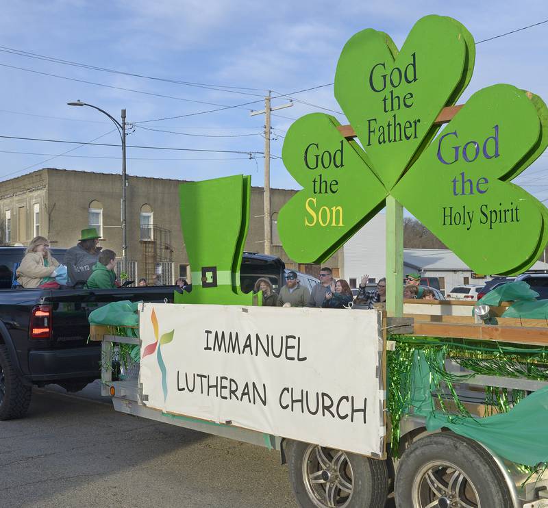 Candiy treats are tossed from the back of the truck pulling the Immanuel Lutheran float along Main St in Marseilles Saturday during the annual St Patrick's Day Parade.