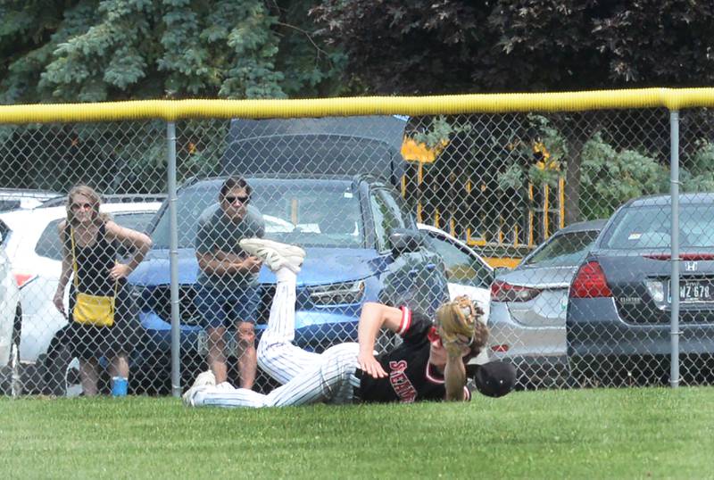 Fulton left fielder Evan Folk shows he caught a sinking fly ball after diving to the ground against River Ridge/Scales Mound at the 1A Lena-Winslow Sectional final on Saturday, May 31, 2025.