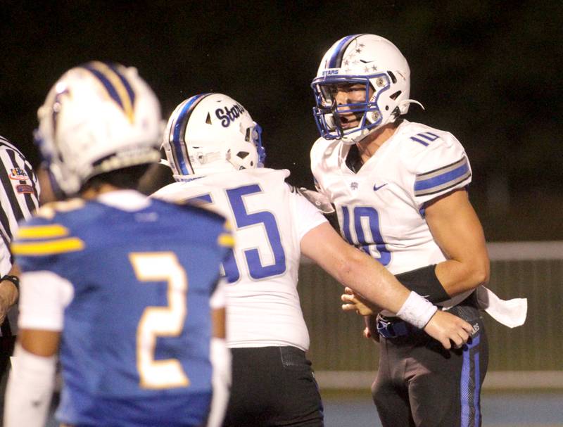 Wheaton North quarterback Ethal Plumb (right) celebrates a touchdown during a game at Wheaton North on Friday, Sept. 8, 2023.