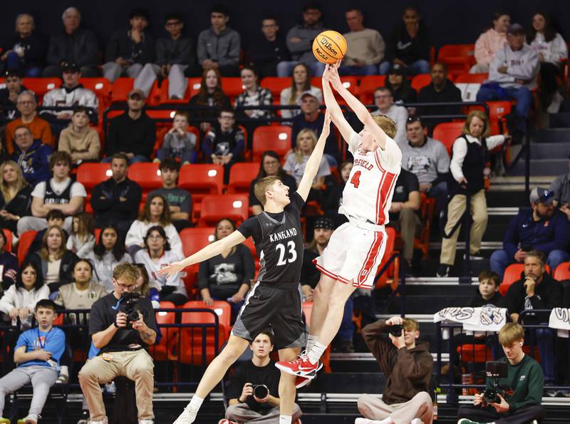 Kaneland's Connor Kimme (23) gets a hand on a shot by Deerfield's Tommy Donahue (4) during the IHSA Class 3A boys basketball state semifinal Friday, March 13, 2026 at the State Farm Center in Champaign.