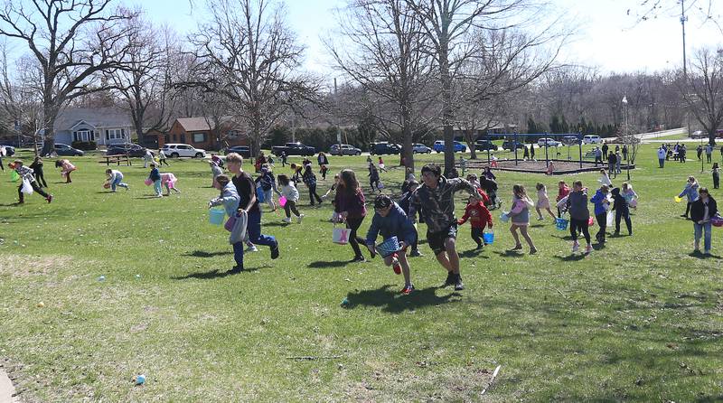 Kids race to find eggs during the Easter Egg Hunt on Saturday, March 28, 2026 at Centennial Park in Peru.