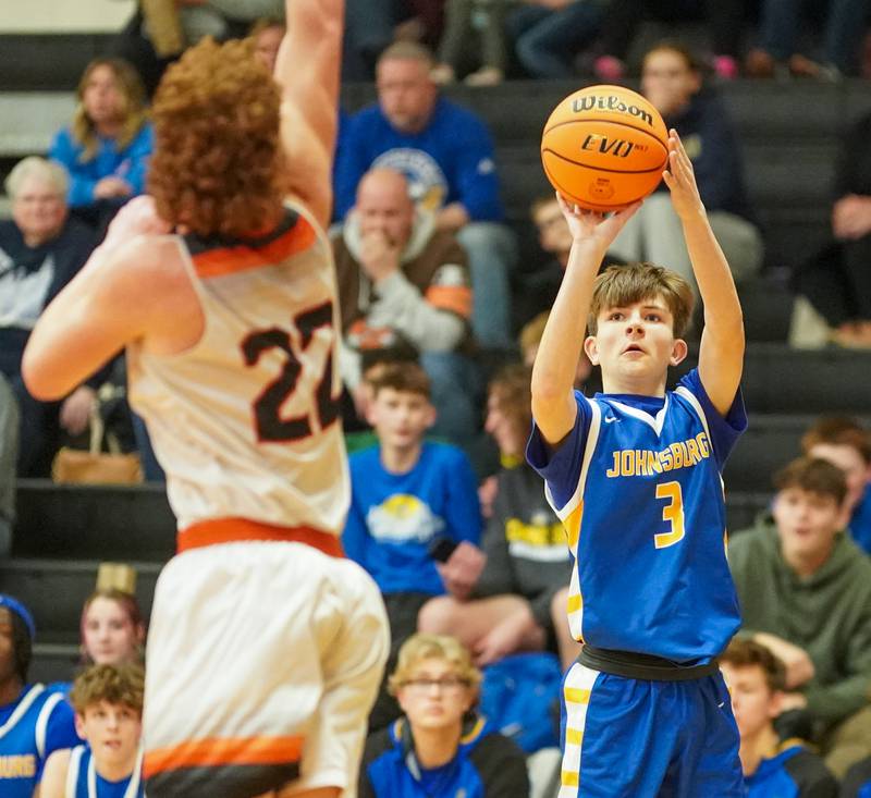 Johnsburg's Trey Toussaint (3) shoots a three pointer against Sandwich’s Dom Rome (22) during a basketball game at Sandwich High School on Friday, January 31, 2025.