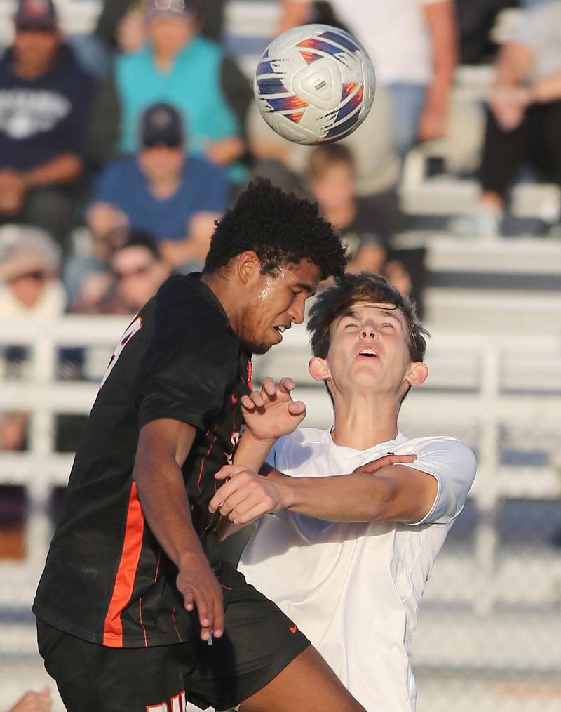 DeKalb's Josiah Antimo (left) and Sycamore's Charlie Roots go up for a header during their game Tuesday, Oct. 4, 2022, at DeKalb High School.