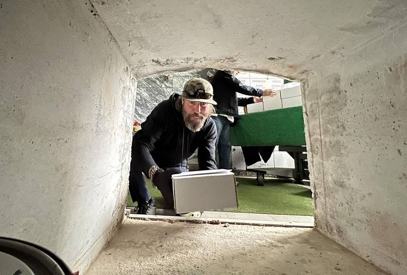 Brooks Ronzheimer, St. Charles Township cemetery superintendent, puts remains of unclaimed ashes of people into an empty vault at North Cemetery in St. Charles on May 27, 2022, after a memorial service arranged by the Kane County coroner. The remains of 35 people were entombed.