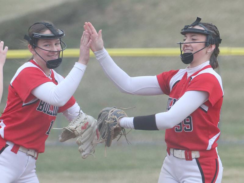 Streator's Caitlyn Talty hi-fives pitcher Makenna Ondrey after striking out an Ottawa batter on Thursday, March 27, 2025 at Ottawa High School.