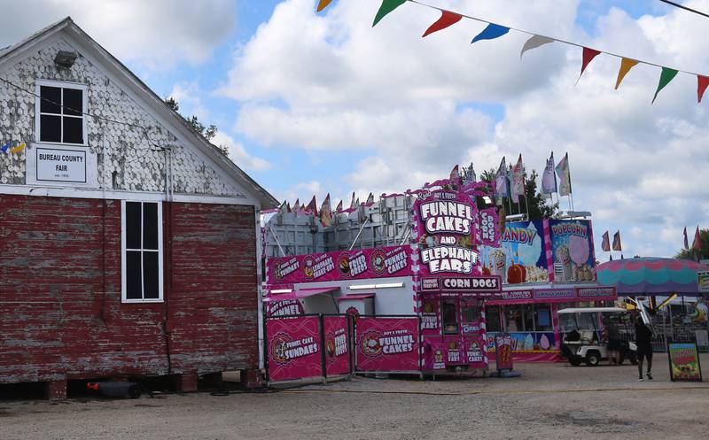 Carnival crews set up rides outside the Bureau County Fair Museum on Wednesday, Aug. 20, 2025 at the Bureau County Fair in Princeton. This year is the 170th annual fair.