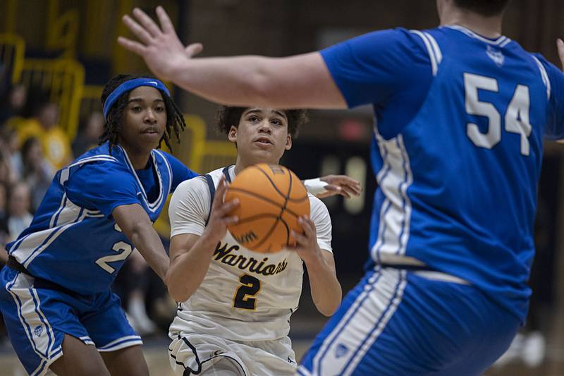 Sterling’s Deandre Maas looks to make a play against Quincy’s Avery Beaston (left) and Brennen Lepper Friday, Jan. 30, 2026.
