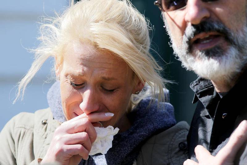 JoAnn Cunningham, the mother of missing 5-year-old Andrew "AJ" Freund, cries as her Crystal Lake attorney, George Kills, talks with the media Friday outside Cunningham's home on Dole Avenue in Crystal Lake.