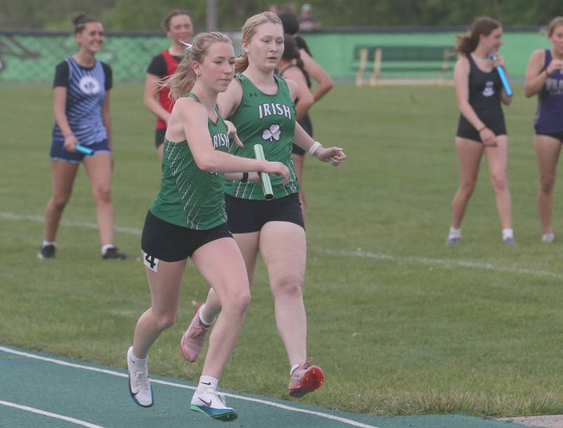 Seneca's Lylah Hebel grabs the baton from teammate Julie Mueller in the 4x800 relay during the Class 1A Sectional track meet on Thursday, May 15, 2025 at Seneca High School.