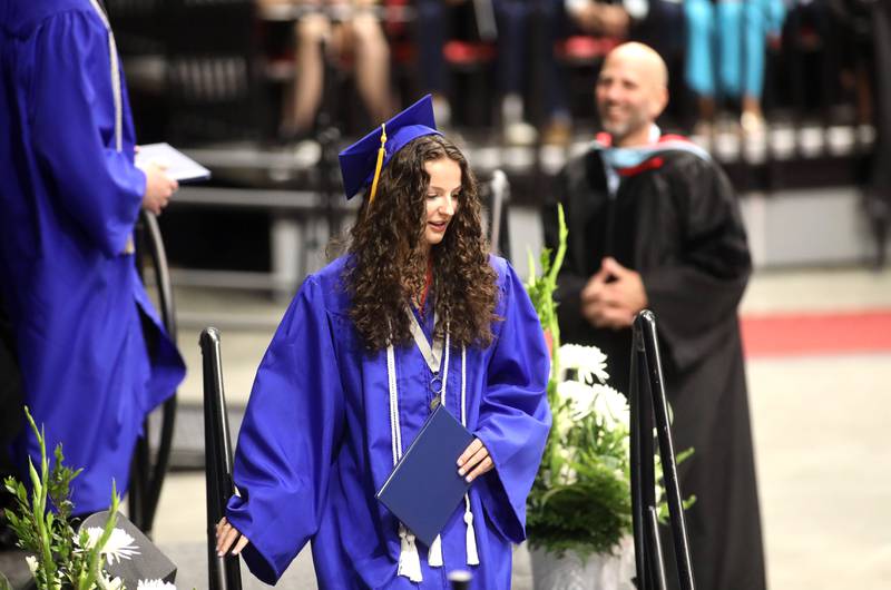 St. Charles North graduate Alex Bardouniotis descends the stairs after getting her diploma during the school’s commencement ceremony at Northern Illinois University in DeKalb on Monday, May 20, 2024.