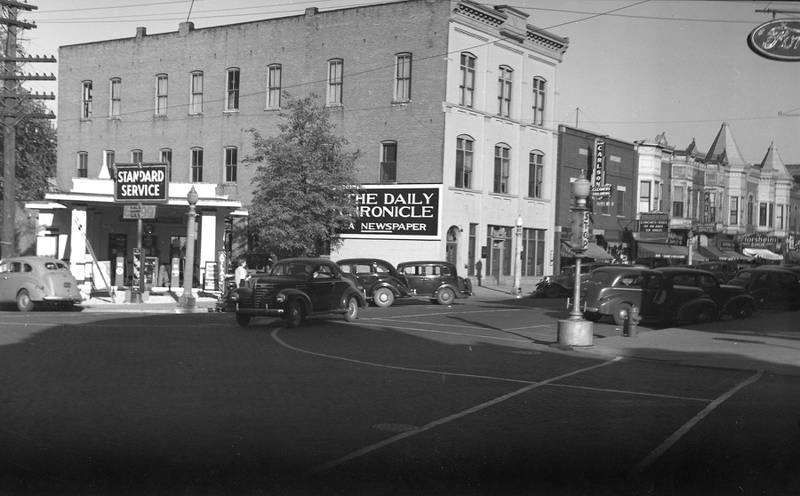 The Daily Chronicle Building and Whitney's Standard Station looking northeast in DeKalb before the station's 1940 remodel.
