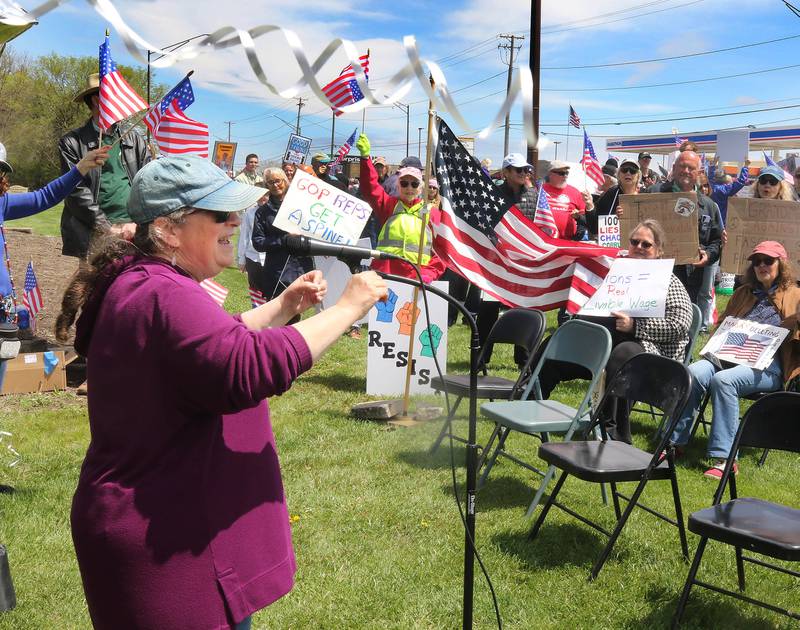 Cynthia de Seife, coordinator of REACT, speaks Saturday, May 3, 2025, at Hopkins Park in DeKalb during a May Day Rally for Democracy to protest against Trump administration policies.