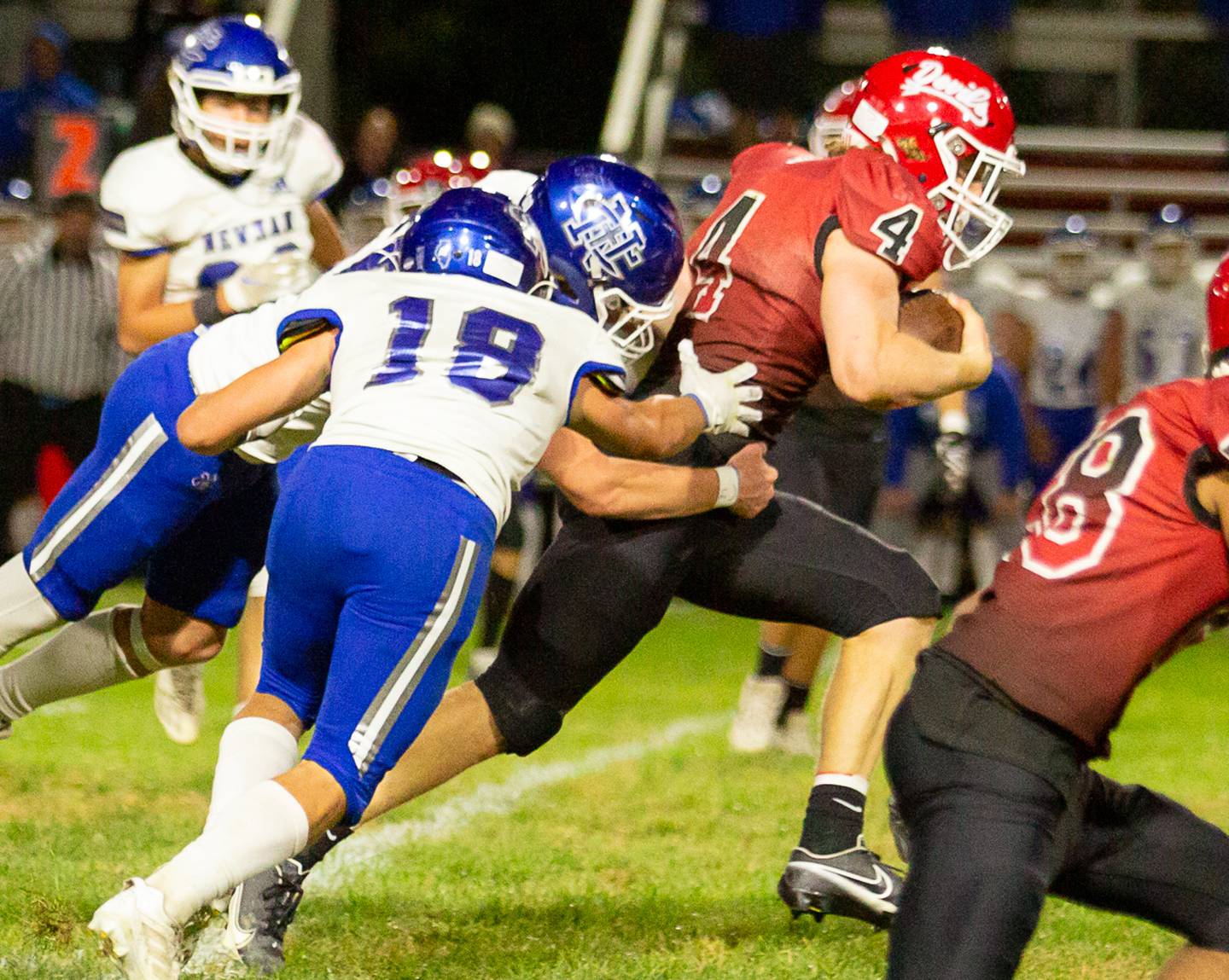 Hall's Mac Resetich (4) runs with the football as Newman's Brady Grennan (18) makes a tackle on Friday, Oct. 7, 2022 at Richard Nesti Stadium.