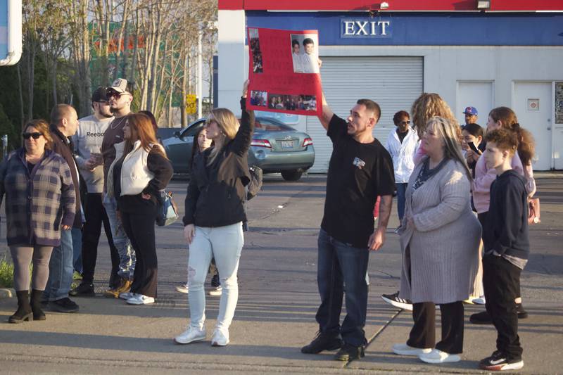 Anthony Malito, the twin brother of David Malito, 39, holds up a sign for a vigil and protest for his brother on Monday, May 5, 2025, at the Shell gas station, 401 S. Larkin Avenue, Joliet.
